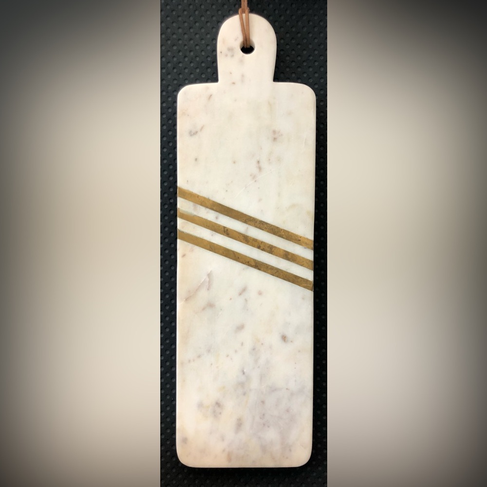 Cynthia Rowley Brass and marble cheese board with leather strap.